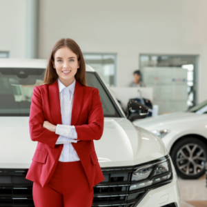 confident woman standing in front of a new car