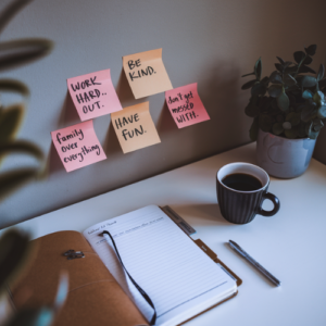 sticky notes with personal values written on them above a person's desk